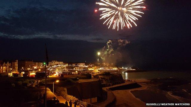 Fireworks light up the night sky at a beach