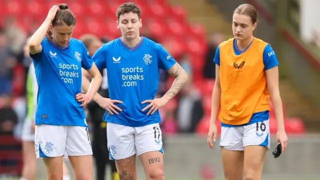 Rangers' Lizzie Arnot, Sarah Ewens and Eilidh Austin look dejected at full time during a Scottish Power Women's Premier League match between Rangers and Celtic