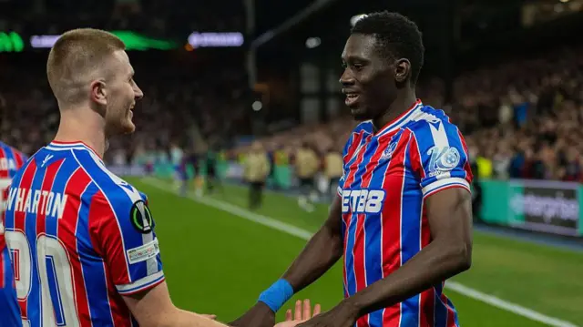Ismaila Sarr and Adam Wharton celebrate a goal