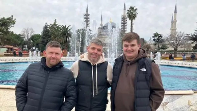Aston Villa fans pose by a fountain in Istanbul