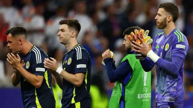 Lawrence Shankland, Kieran Tierney and Angus Gunn applaud fans in Munich