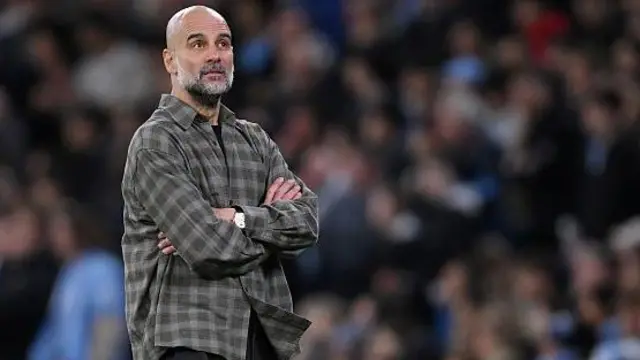 Pep Guardiola looks on