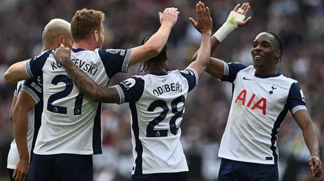 Wilson Odobert of Tottenham celebrates with Dejan Kulusevski and Mathys Tel after scoring.