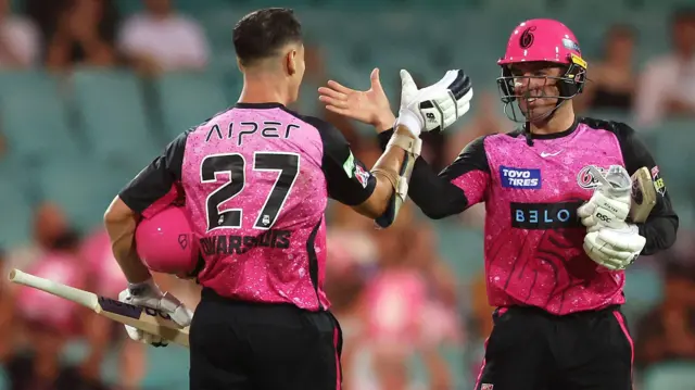 Sydney Sixers captain Moises Henriques and Ben Dwarshuis celebrate their win over Melbourne Renegades