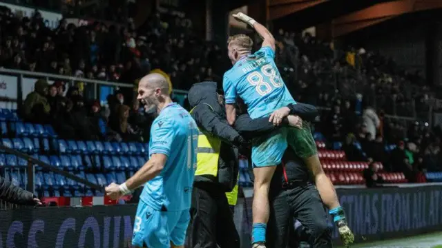 Alex Gogic and Killian Phillips celebrate