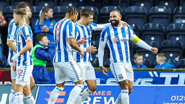 Teammates celebrate with Kyle Vassell after he opens the scoring against Aberdeen