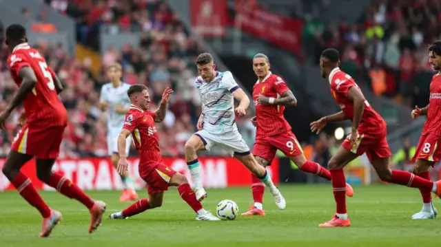 Liverpool players challenging for the ball against Bournemouth