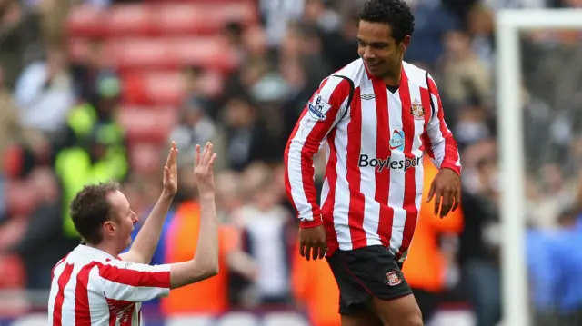Kieran Richardson is saluted by a fan on his knees on the pitch at full time