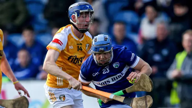 Antrim's James McNaughton battles with Laois' Tomas Keyes