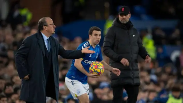 Seamus Coleman goes to take a throw-in as Jurgen Klopp watches on