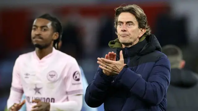 Thomas Frank applauds the Brentford fans after the Bees' Premier League defeat at Aston Villa