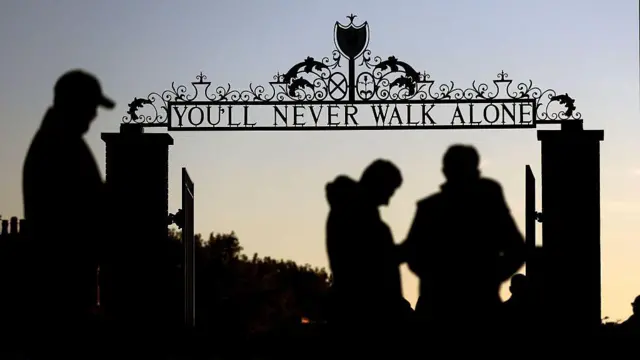  A silhouetted view of the Shankly Gates outside Anfield which read 'You'll Never Walk Alone'
