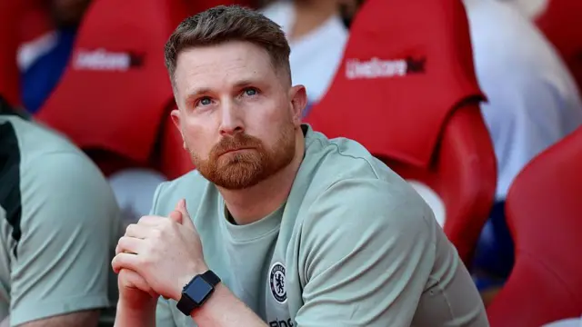 Calum McFarlane clasps his hands together on Chelsea's bench