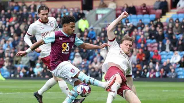 Rob Dickie (right) slides to make a tackle