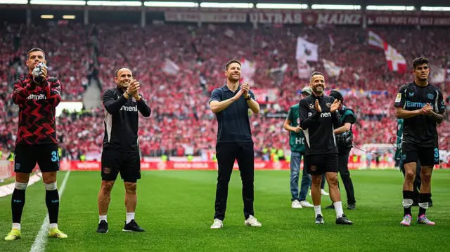 Xabi Alonso, Sebastian Parrilla and Ismael Camenforte Lopez applauding Bayer Leverkusen 