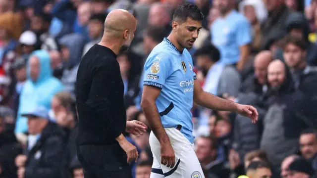 Rodri of Manchester City and Pep Guardiola manager of Manchester City as he goes off injured during the Premier League match between Manchester City FC and Arsenal FC at Etihad Stadium