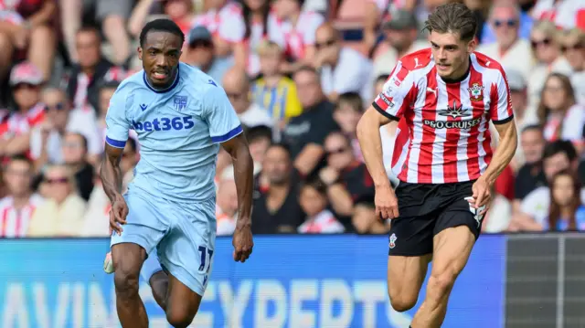Stoke City's Eric Bocat put under pressure by Southampton's Tom Fellows during their Championship match on Saturday