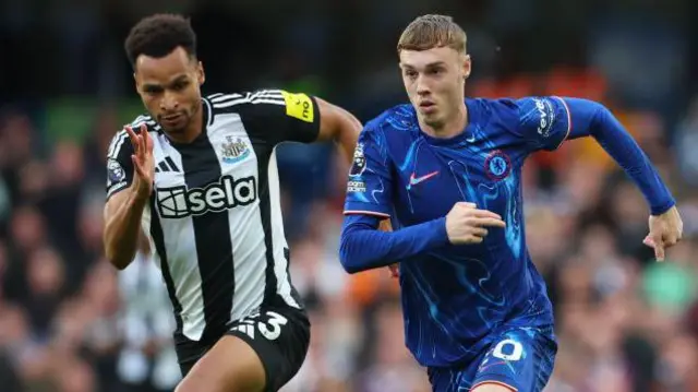 Jacob Murphy of Newcastle United and Cole Palmer of Chelsea on the ball during the Premier League match between Chelsea FC and Newcastle United FC at Stamford Bridge on October 27, 2024