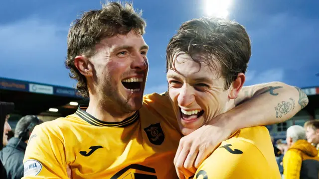 Livingston’s Robbie Muirhead (L) and Daniel Finlayson celebrate at full time of the William Hill Premiership Play-Off Final 2nd Leg match between Ross County and Livingston at the Global Energy Stadium, on May 26, 2025, in Dingwall