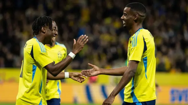 Anthony Elanga of Sweden celebrates with teammate Alexander Isak