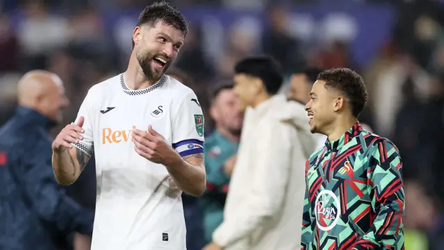 Cameron Burgess and Manuel Benson celebrate after Swansea's win over Nottingham Forest