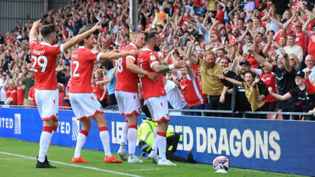 Wrexham celebrate in front of their home fans during the win over Wycombe Wanderers