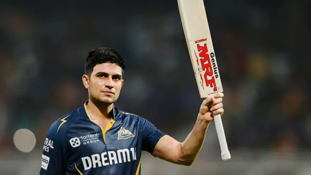 Gujarat Titans' Shubman Gill raises his bat after being dismissed for 90