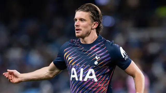 Conor Gallagher with his arm outstretched while running and playing football