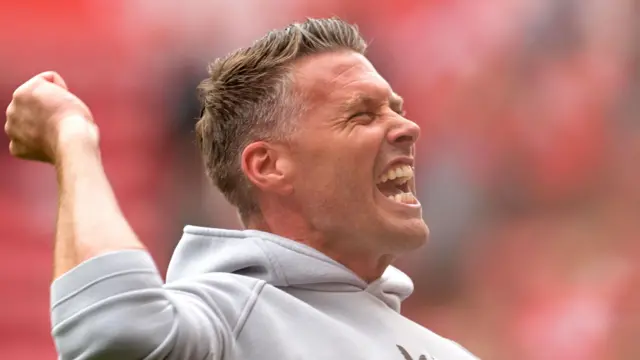 Rob Edwards punches the air in the direction of Middlesbrough fans after they beat Sheffield United