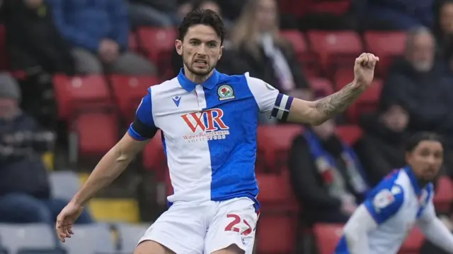 Blackburn Rovers captain Lewis Travis passing the ball