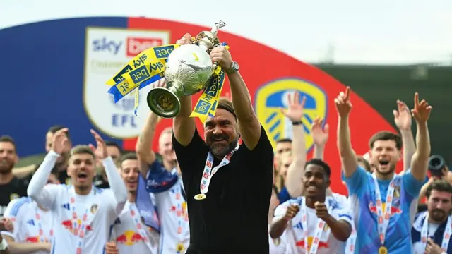 Daniel Farke lifting Championship trophy
