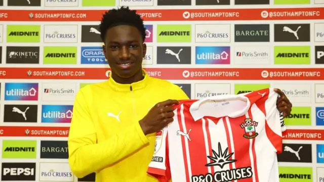 Southampton's latest signing Issa Tounkara poses for a photo holding the shirt