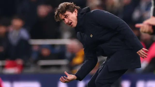 Thomas Frank bending over and looking frustrated on the touchline