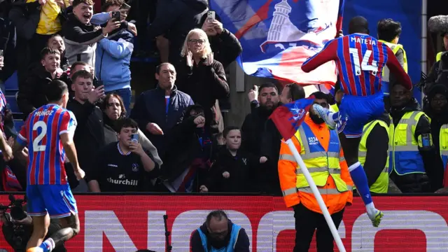 Jean-Philippe Mateta kicks the corner flag in celebration after scoring