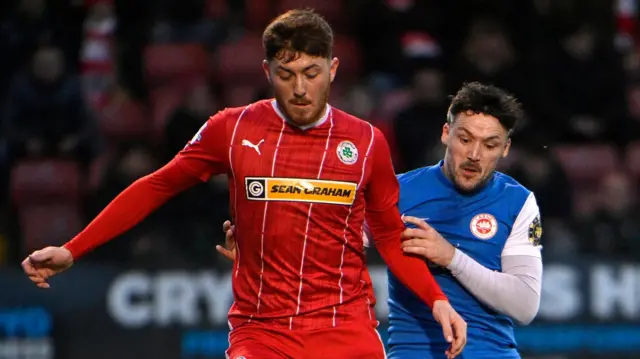 Cliftonville’s Sean Stewart in action with Larne’s Tomas Cosgrove