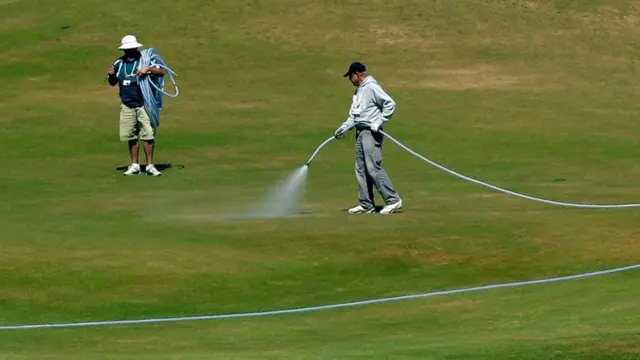 Staff water the Chambers Bay course