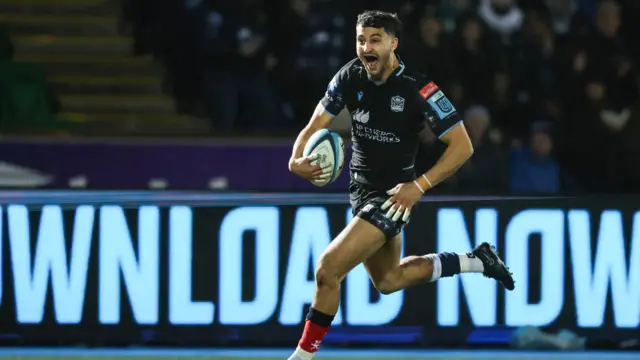 Afshar beams as he runs in his first professional try for Glasgow