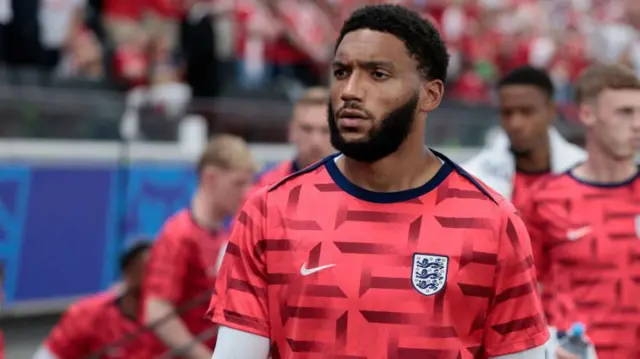 Joe Gomez warms up before an England match