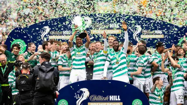 Celtic players celebrate with Premiership trophy