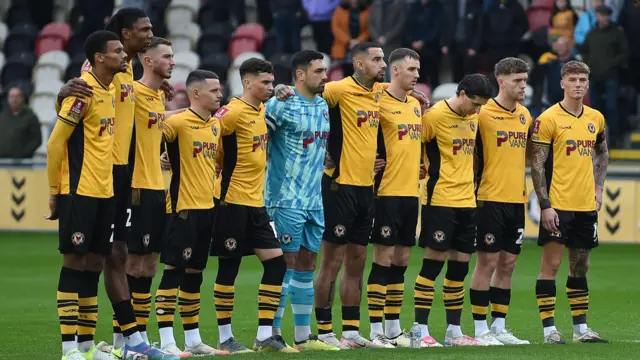 Newport players line up before their FA Cup loss to Peterborough