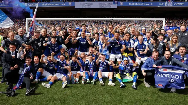 The Ipswich players and staff celebrate their promotion to the Premier League after the EFL Championship