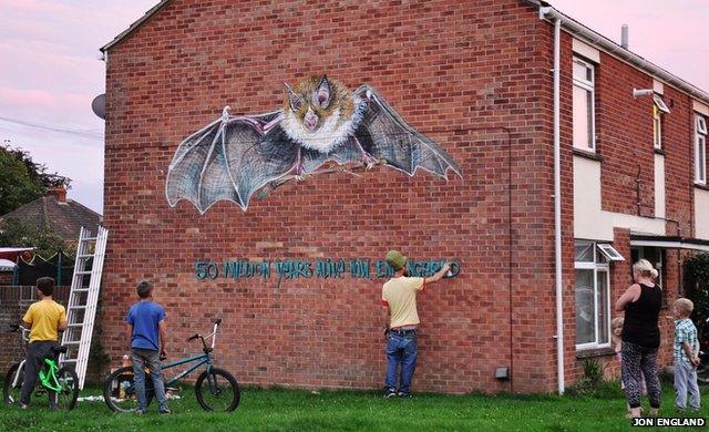 Bat painting on the side of a house. Artist Louis Masai, SAW and Somerset Wildlife Trust - Routes to the River Tone. Photo: Jon England