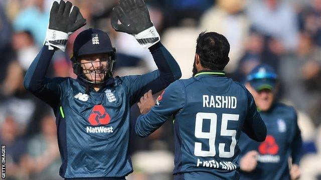 England's Jos Buttler and Adil Rashid celebrate taking a wicket