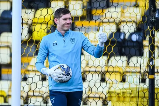 Michael McGovern with a thumbs up while holding a ball