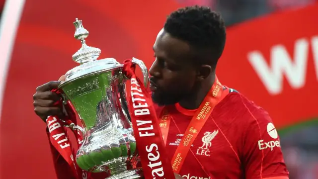 Divock Origi of Liverpool kisses the FA Cup trophy