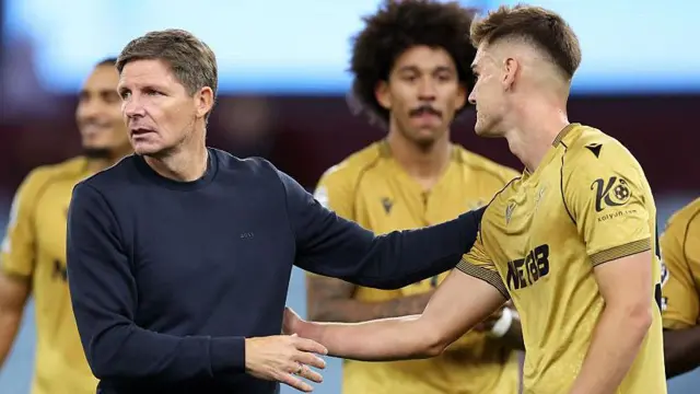 Oliver Glasner, Manager of Crystal Palace, greets player Justin Devenny