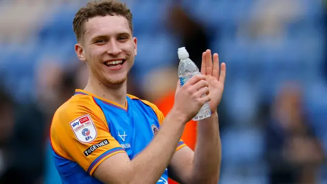 Iwan Morgan applauds the fans after a game for Shrewsbury Town