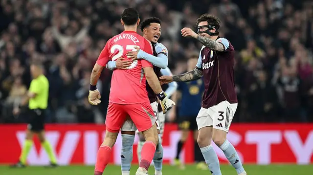 Emiliano Martinez, Jadon Sancho and Victor Lindeloef of Aston Villa celebrate their side's first goal scored by John McGinn of Aston Villa