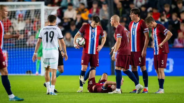 Martin Odegaard lies injured on the pitch  during Norway's game against Austria