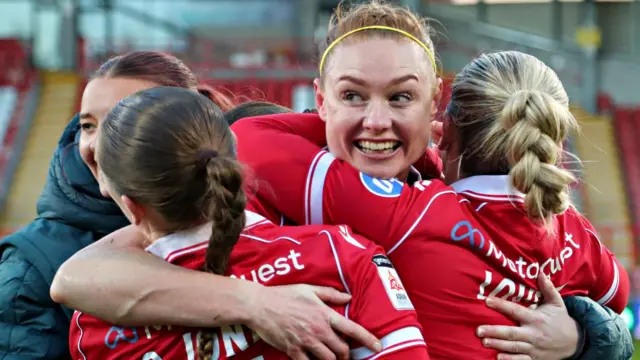 Wrexham players celebrate their win over Cardiff City which clinched the title